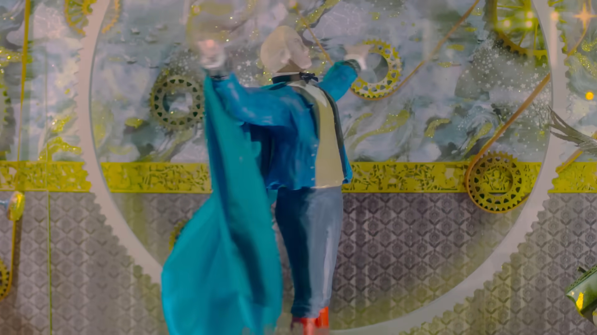 A mannequin wearing a cape.